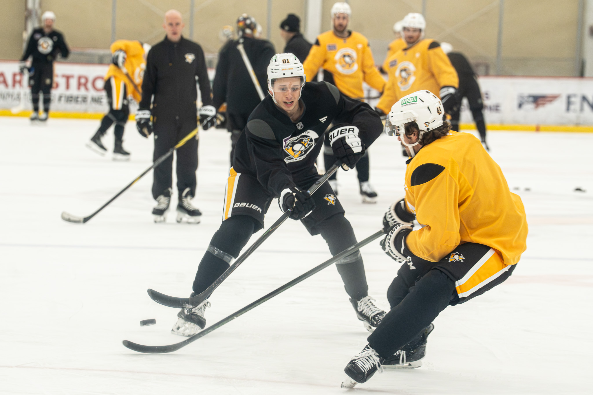 Ben Kindel and Sam Girard compete for a puck.