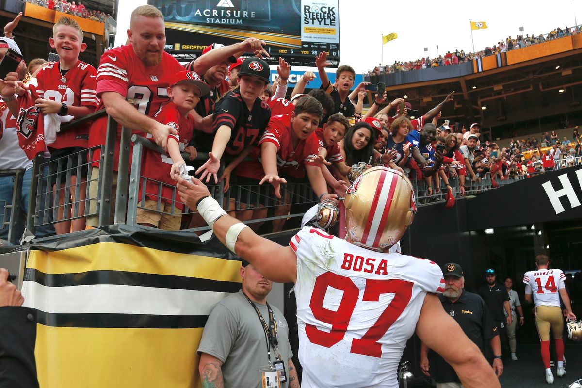 The 49ers' Nick Bosa slaps hands with San Francisco fans after the game Sunday at Acrisure Stadium.