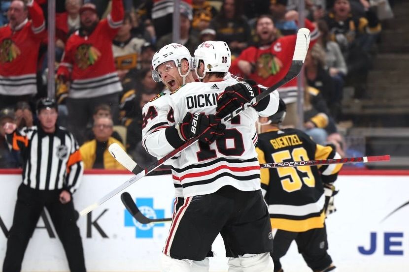 The Blackhawks' Corey Perry and Jason Dickinson celebrate the latter's winning goal in the third period.