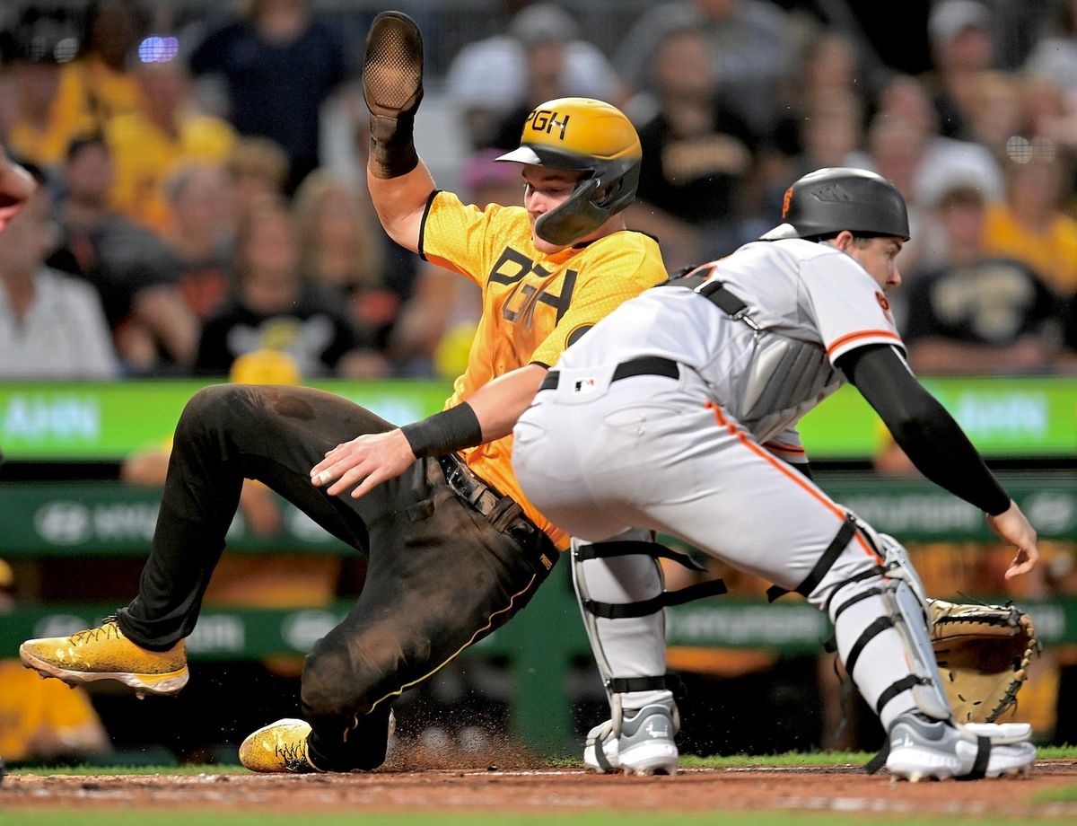 Henry Davis before the outfield throw reaches the Giants' Patrick Bailey in the fifth inning Friday night at PNC Park.