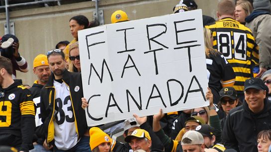 A fan holds a sign calling for Matt Canada's firing in the first quarter Sunday at Acrisure Stadium.