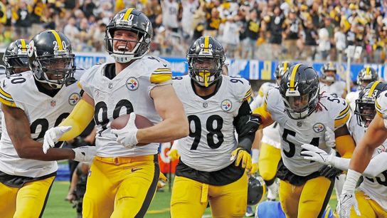 T.J. Watt and his defensive mates celebrate his interception.