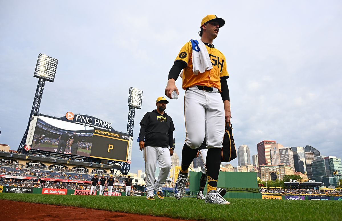 Paul Skenes, with Oscar Marin behind him, walks from the bullpen to the dugout before the game Friday night at PNC Park.