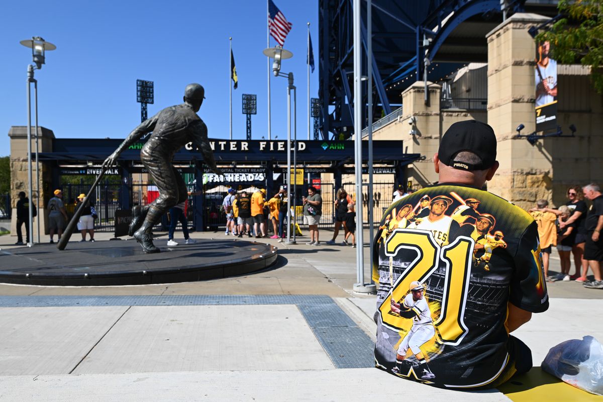 A fan sits near the Roberto Clemente statue Thursday outside PNC Park.