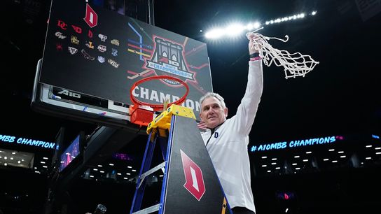 Keith Dambrot takes down the Atlantic 10 Conference championship net Sunday in New York.