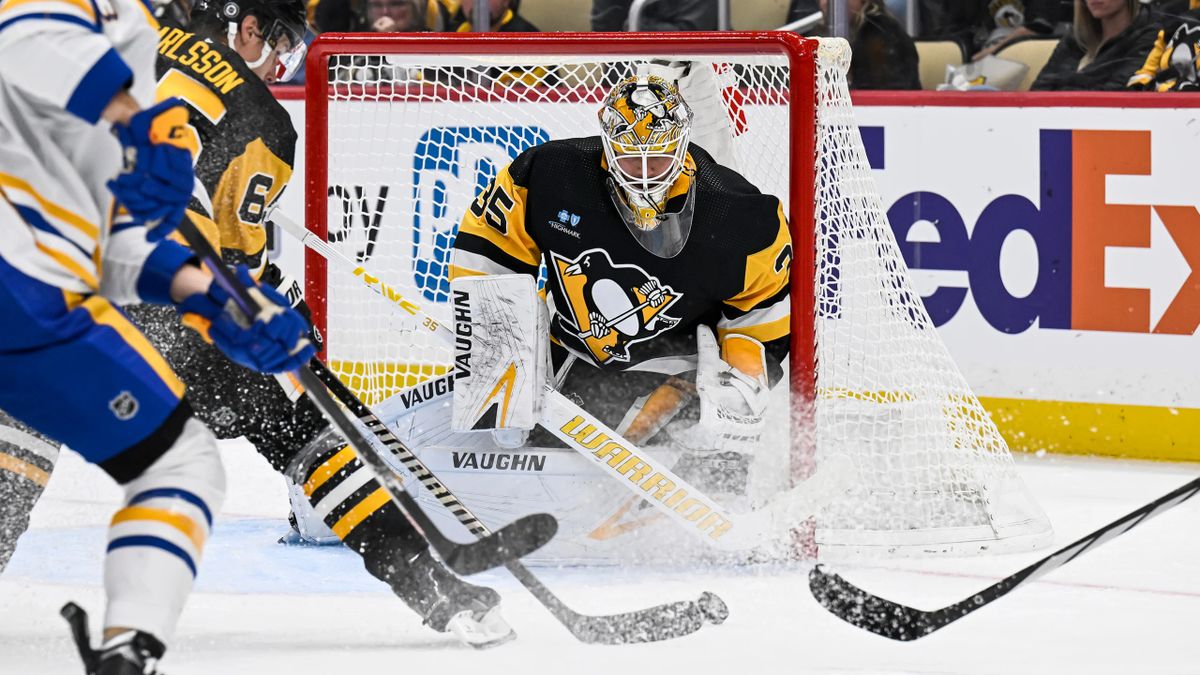 Erik Karlsson clears the puck from Tristan Jarry's crease Saturday night at PPG Paints Arena.