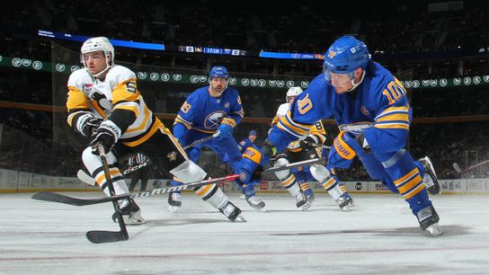 Ryan Shea and Henri Jokiharju battle for the puck Friday night in Buffalo, N.Y.