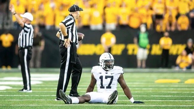 Arnold Ebiketie takes a break for an injury during Penn State's visit to Iowa in 2021.