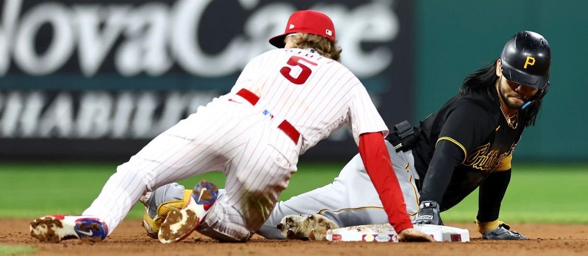 Connor Joe dives back to second base after his double in the third inning Wednesday night in Philadelphia.