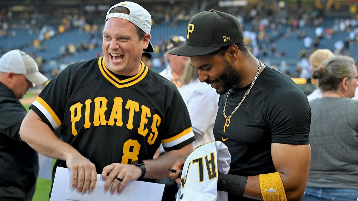 Joshua Palacios gives her jersey to a fan after the Pirates' win Sunday over the Marlins.