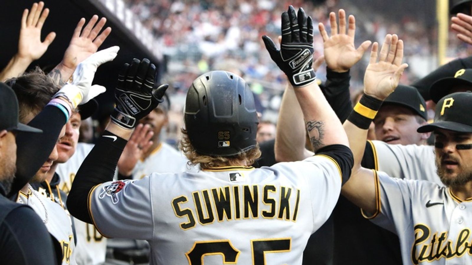 Pittsburgh Pirates right fielder Jack Suwinski loses his cap while