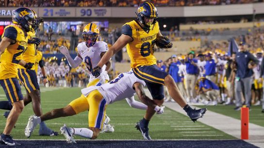 West Virginia's Kole Taylor eludes Pitt's A.J. Woods and Donovan McMillon for a 7-yard touchdown catch in the second quarter Saturday night in Morgantown, W.Va. 