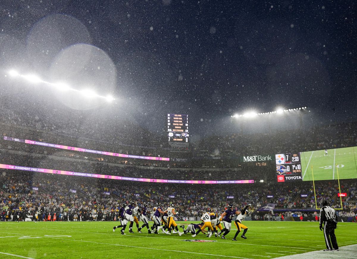 The Steelers and Ravens play through a winter-storm downpour Saturday in Baltimore.