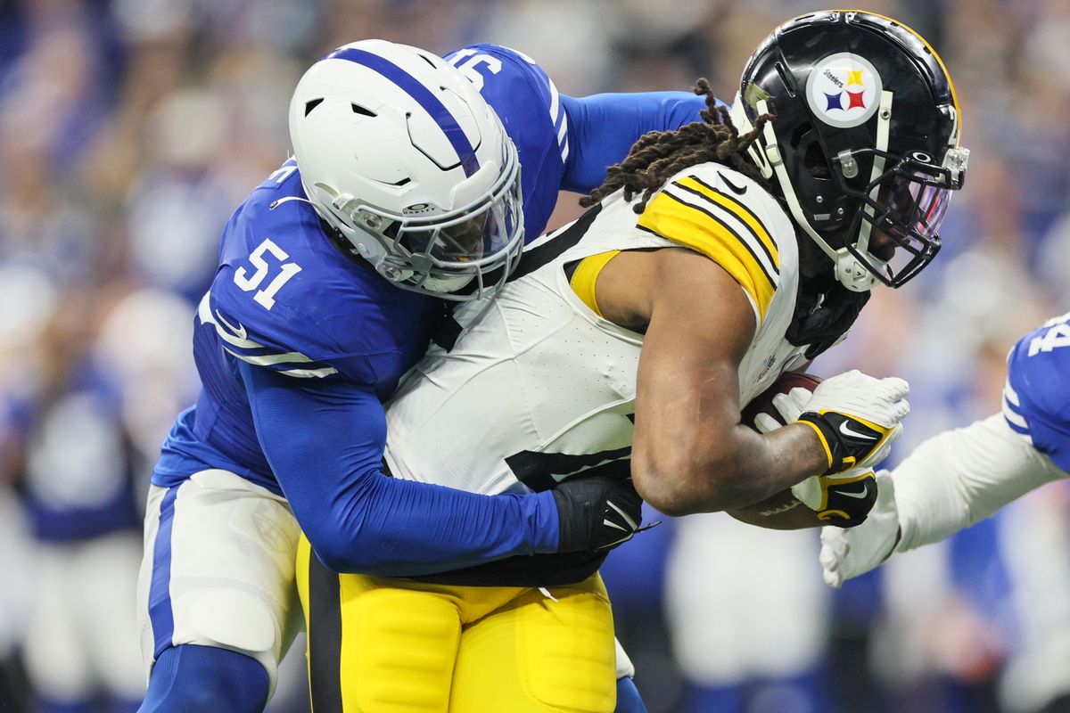 Najee Harris is stopped for no gain by the Colts' Kwity Paye in the second quarter Saturday in Indianapolis.