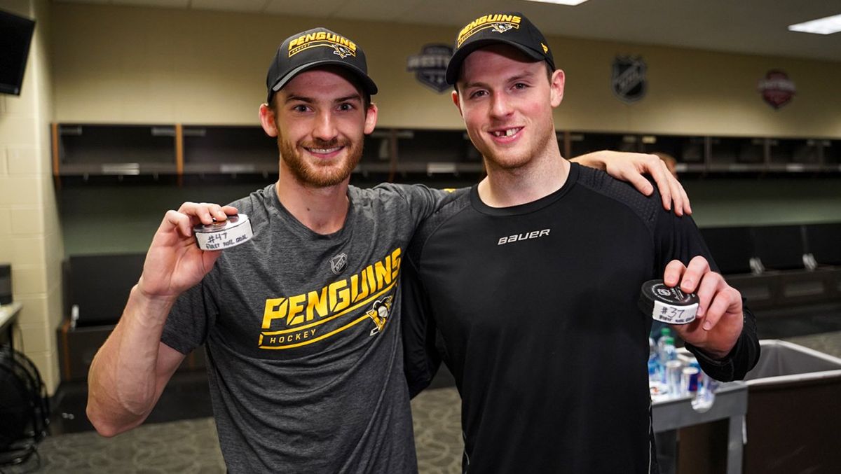 Adam Johnson and Sam Lafferty with their first NHL goal pucks after each scoring in Minnesota