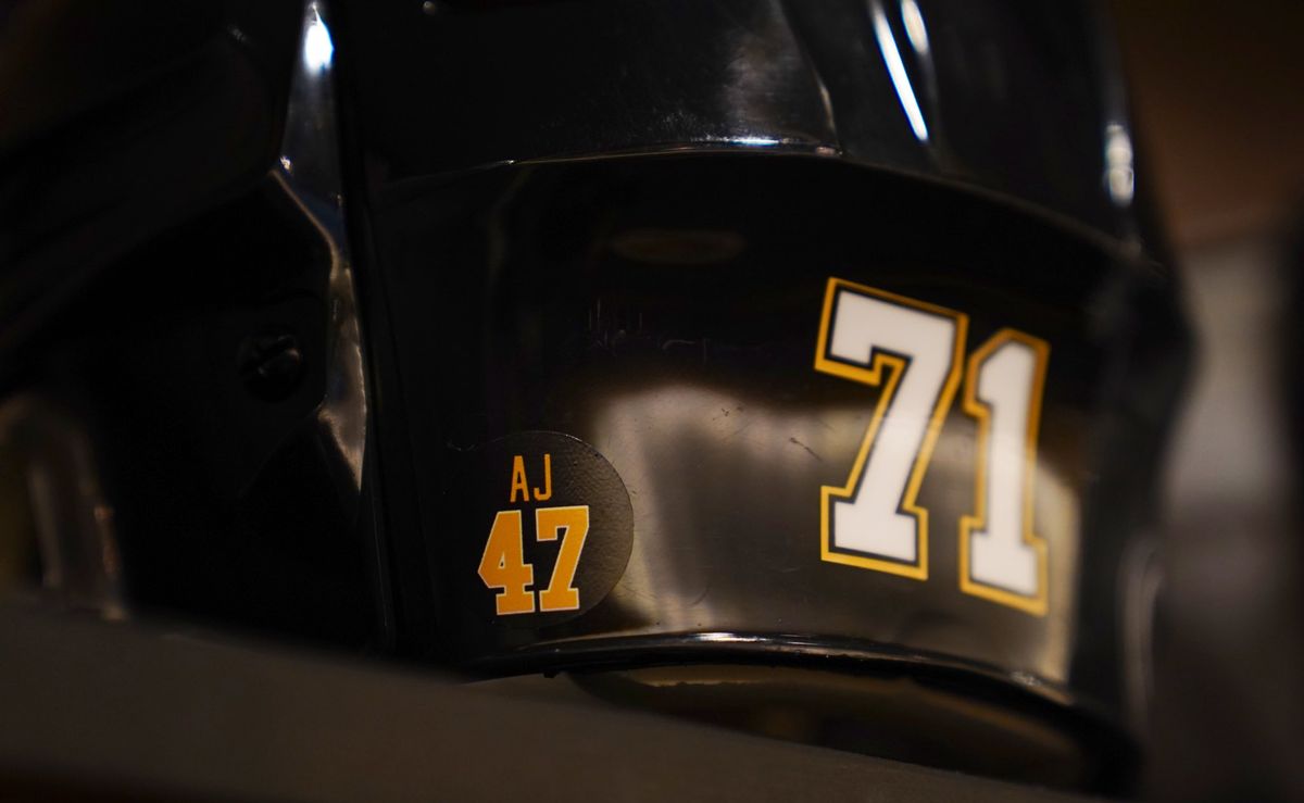 The sticker remembering Adam Johnson on the back of Evgeni Malkin's helmet on Monday.