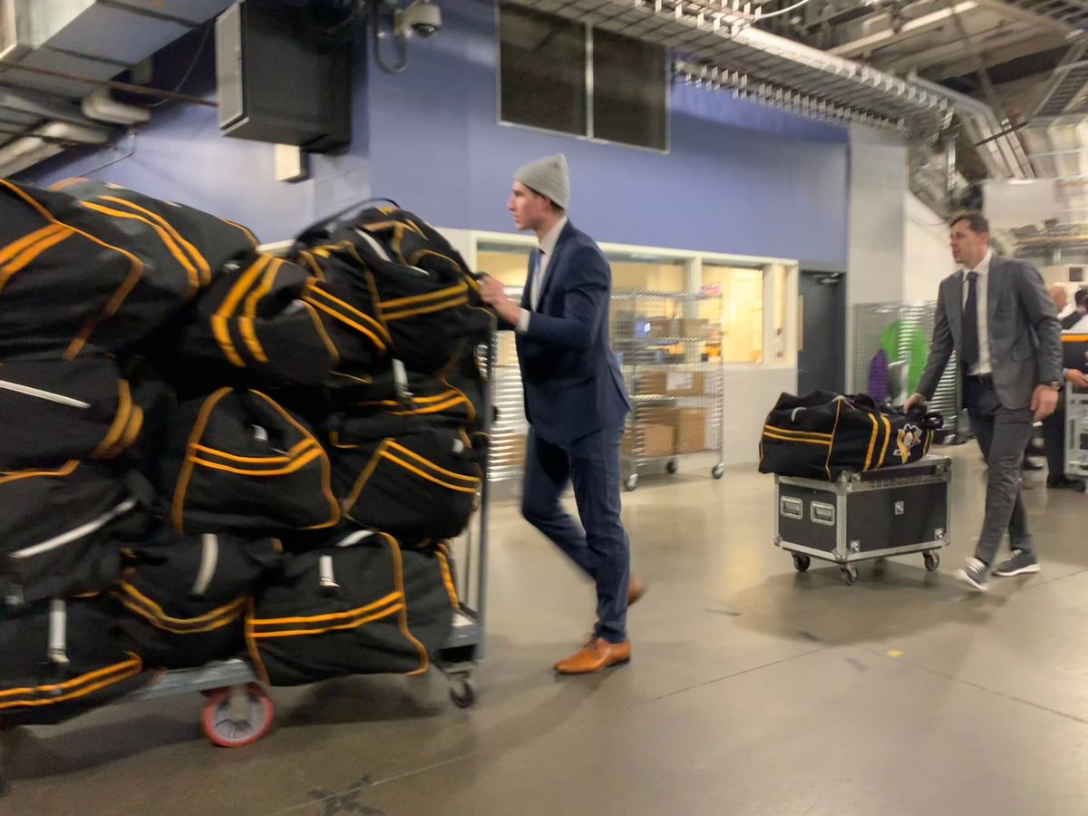 Drew O'Connor and Evgeni Malkin help move equipment to the Penguins' locker room before Friday's game in Buffalo, N.Y.