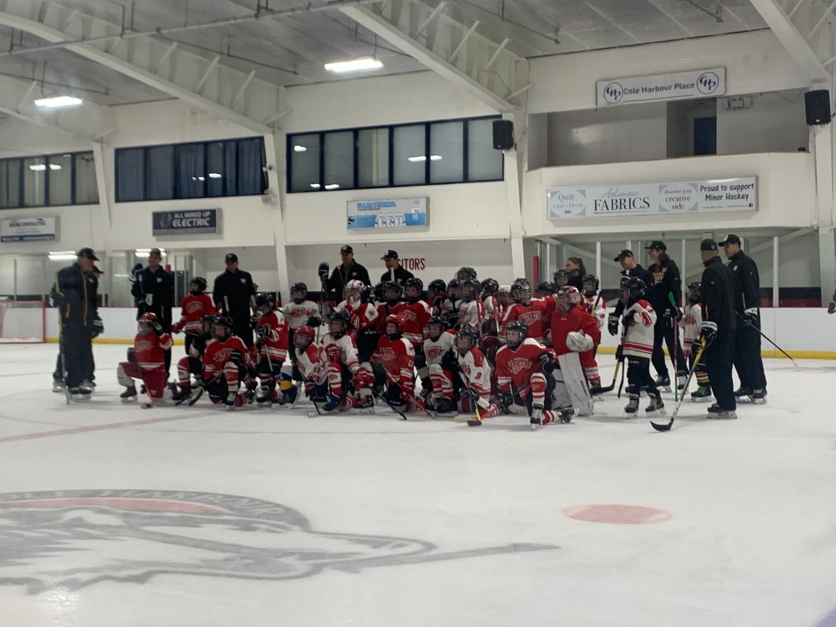 Penguins players and coaches with the Cole Harbour Wings players