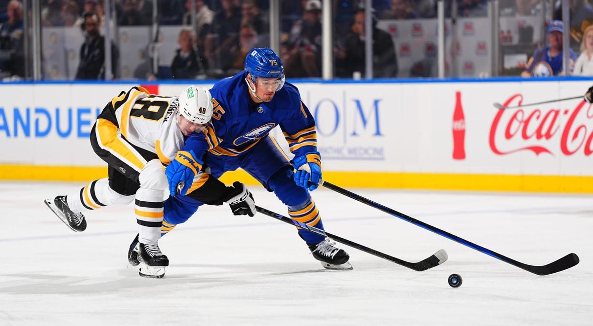 Valtteri Puustinen battles for a puck with Connor Clifton Saturday night in Buffalo, N.Y.